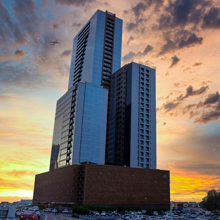 Luxe Grand Hotel Apartments Sharjah Exteriör bild The building at sunset