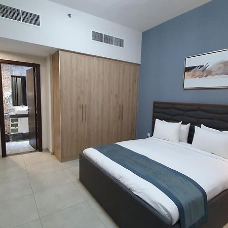Luxe Grand Hotel Apartments Sharjah Exteriör bild A bedroom in a hotel