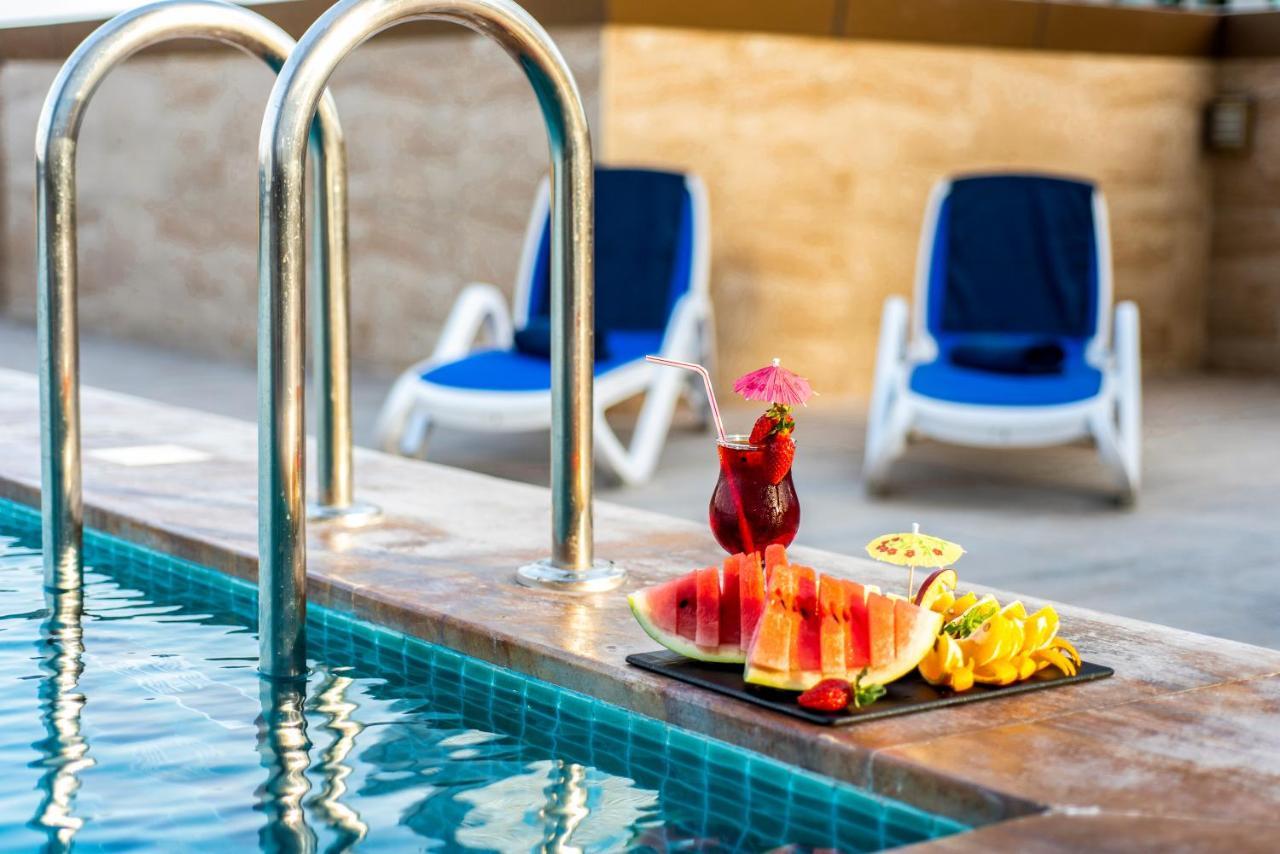 Luxe Grand Hotel Apartments Sharjah Exteriör bild Pool at the hotel