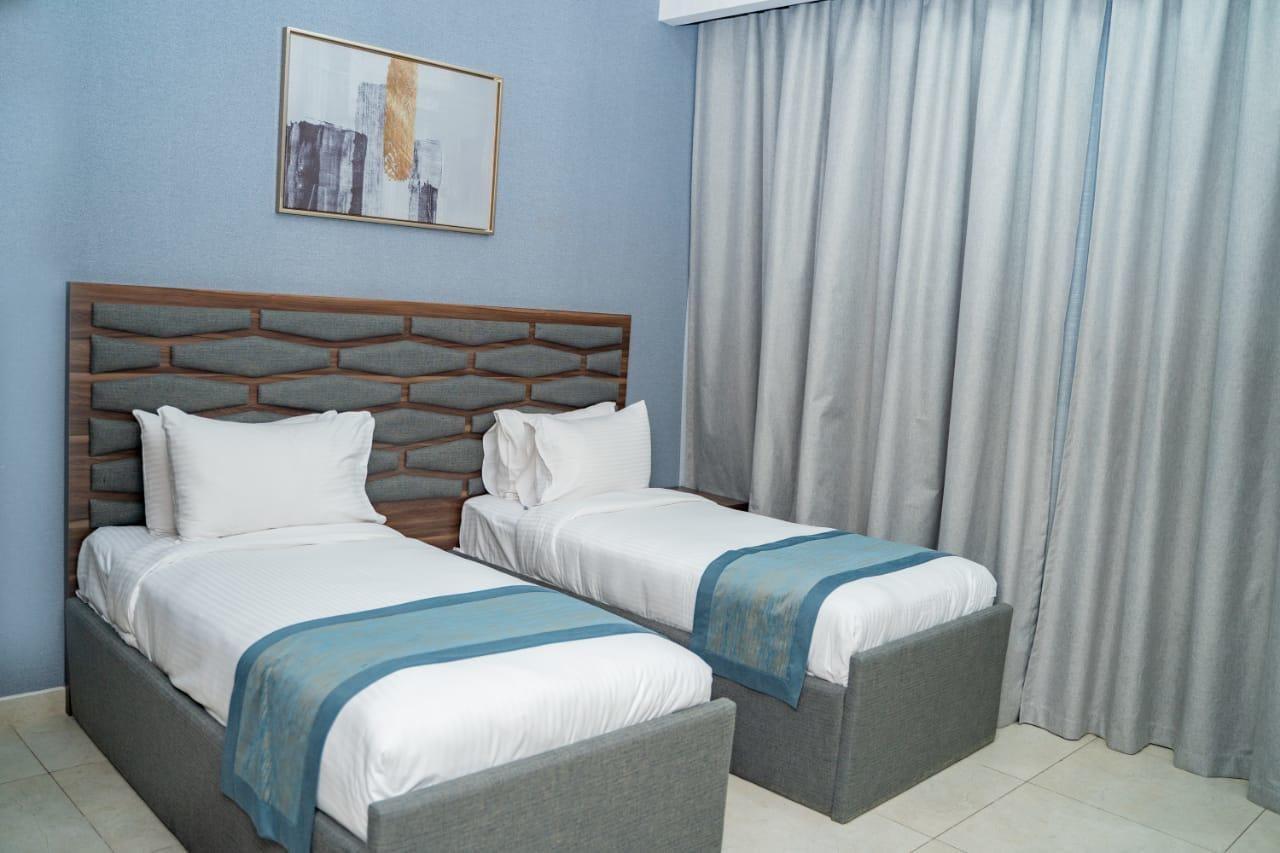 Luxe Grand Hotel Apartments Sharjah Exteriör bild A bedroom at the hotel
