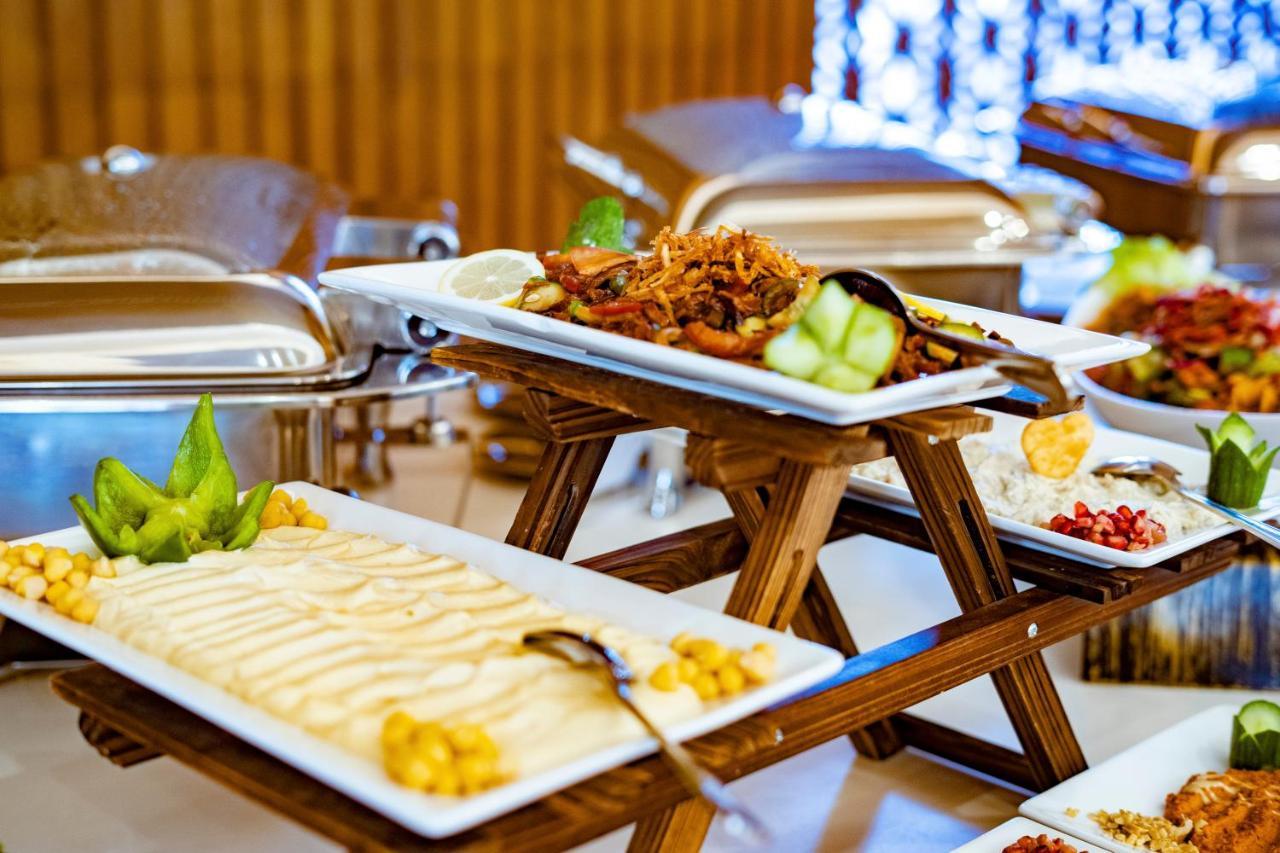 Luxe Grand Hotel Apartments Sharjah Exteriör bild A buffet at a hotel