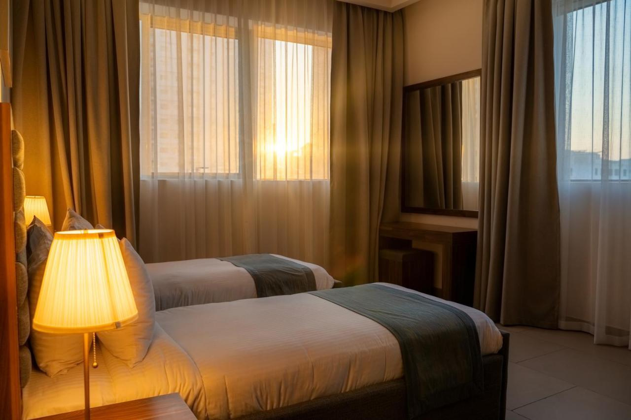 Luxe Grand Hotel Apartments Sharjah Exteriör bild A bedroom at the hotel