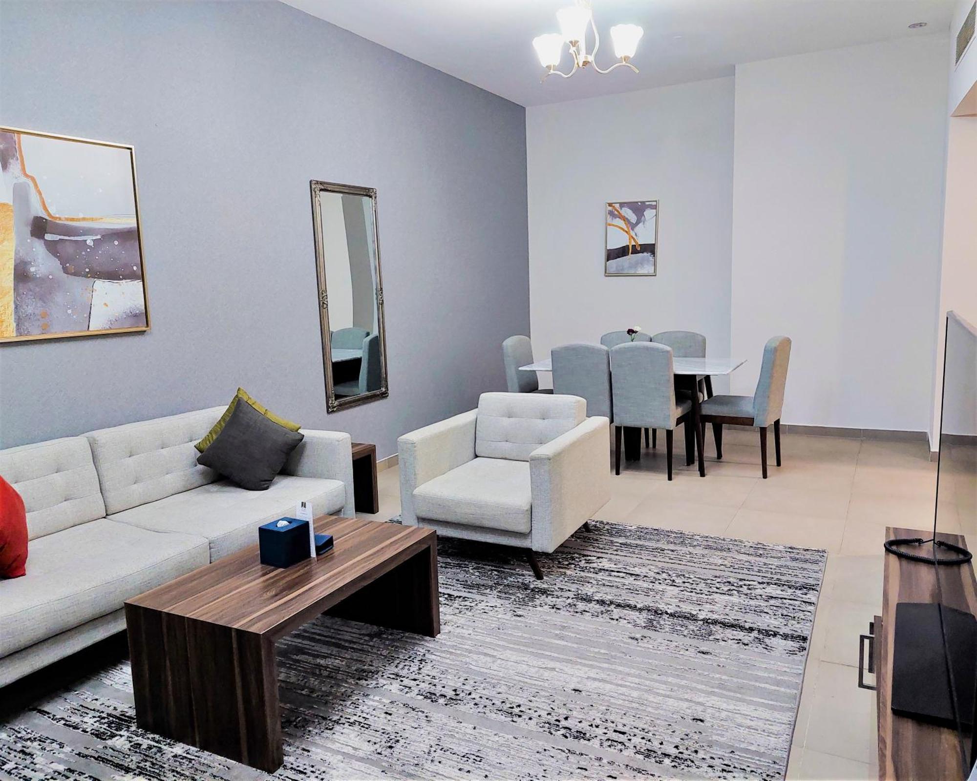 Luxe Grand Hotel Apartments Sharjah Exteriör bild A living room in a typical apartment